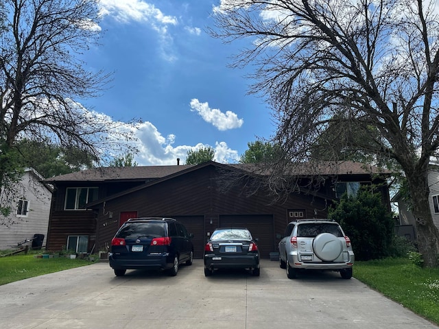 7933 Lee Ave N, Brooklyn Park, MN 55443 - view of front facade with a garage and concrete driveway