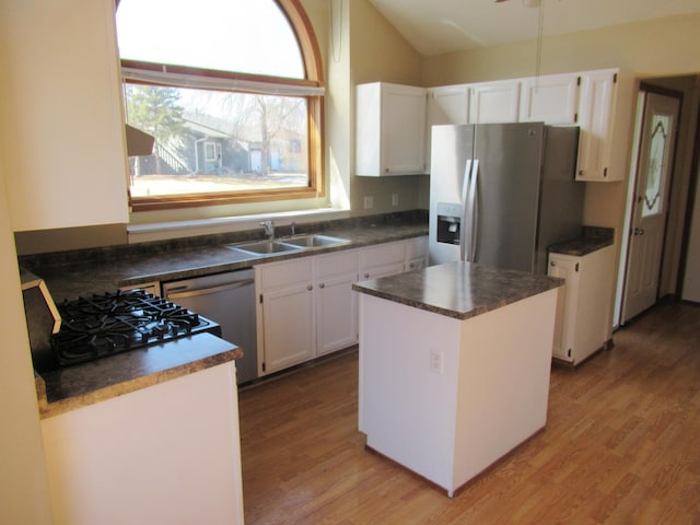 13437 Zarthan Ave S, Savage, MN 55378 - kitchen with appliances with stainless steel finishes, light wood-style flooring, dark countertops, vaulted ceiling, and white cabinets