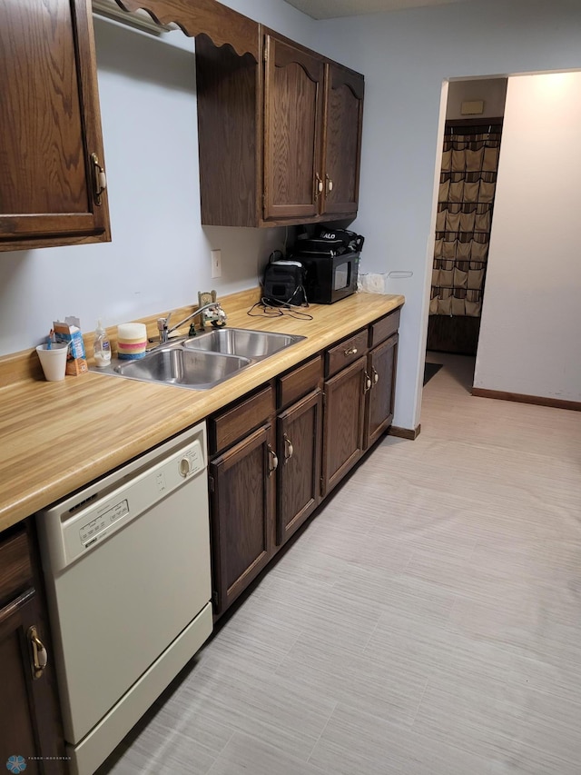 2402 18th St S Unit 3, Fargo, ND 58103 - kitchen with white dishwasher, light countertops, dark brown cabinets, and black microwave