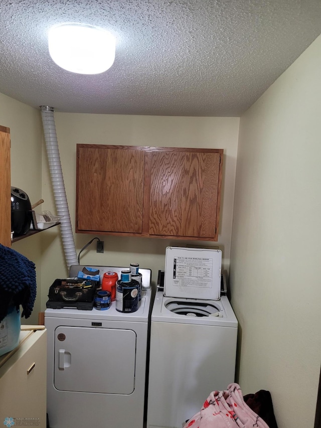 2402 18th St S Unit 3, Fargo, ND 58103 - laundry room with independent washer and dryer, cabinet space, and a textured ceiling