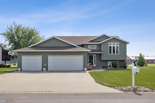 421 2nd Ave S, Kindred, ND 58051 - tri-level home with a garage, concrete driveway, a front yard, and roof with shingles