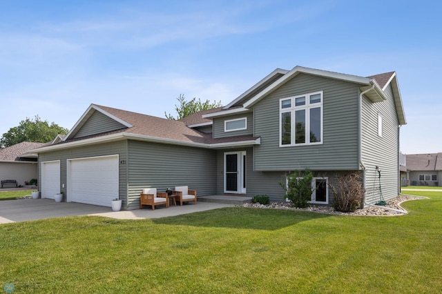 421 2nd Ave S, Kindred, ND 58051 - tri-level home featuring an attached garage, concrete driveway, a front yard, and roof with shingles