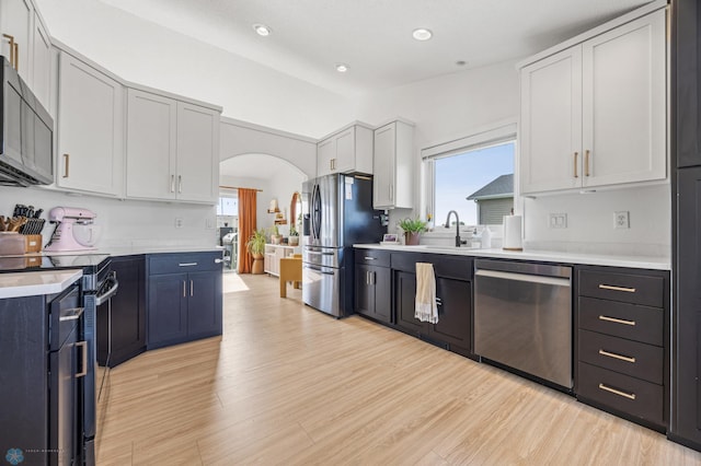 421 2nd Ave S, Kindred, ND 58051 - kitchen with stainless steel appliances, healthy amount of natural light, light countertops, arched walkways, and recessed lighting