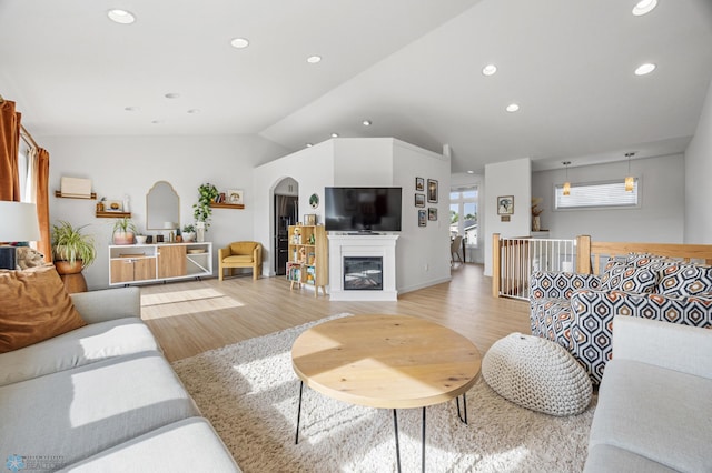 421 2nd Ave S, Kindred, ND 58051 - living room featuring arched walkways, light wood-style floors, vaulted ceiling, and recessed lighting