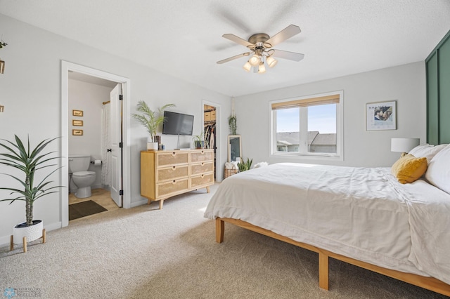 421 2nd Ave S, Kindred, ND 58051 - bedroom with a walk in closet, carpet, ensuite bathroom, a closet, and ceiling fan