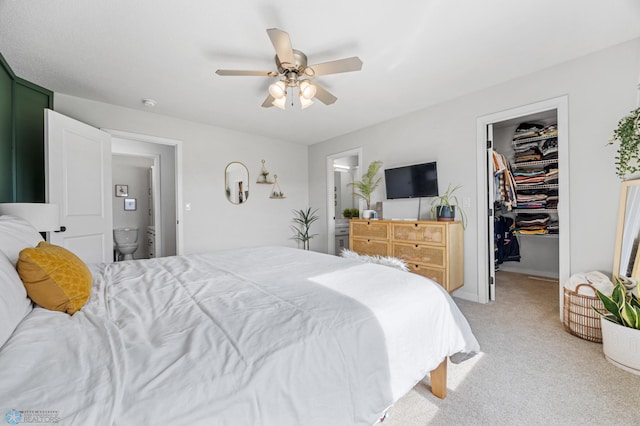 421 2nd Ave S, Kindred, ND 58051 - bedroom with a walk in closet, light carpet, ensuite bath, a closet, and ceiling fan