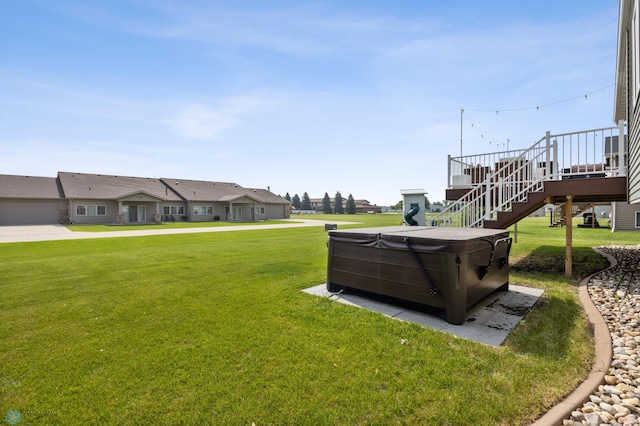 421 2nd Ave S, Kindred, ND 58051 - view of grassy yard featuring a hot tub, stairway, and a wooden deck
