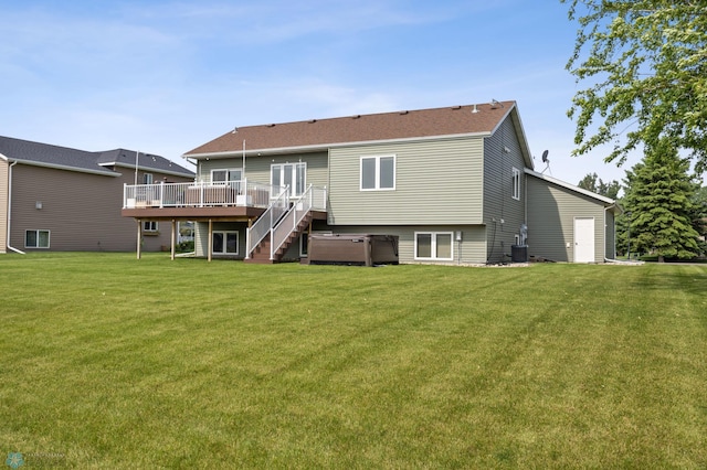 421 2nd Ave S, Kindred, ND 58051 - back of house featuring a hot tub, a wooden deck, and a yard