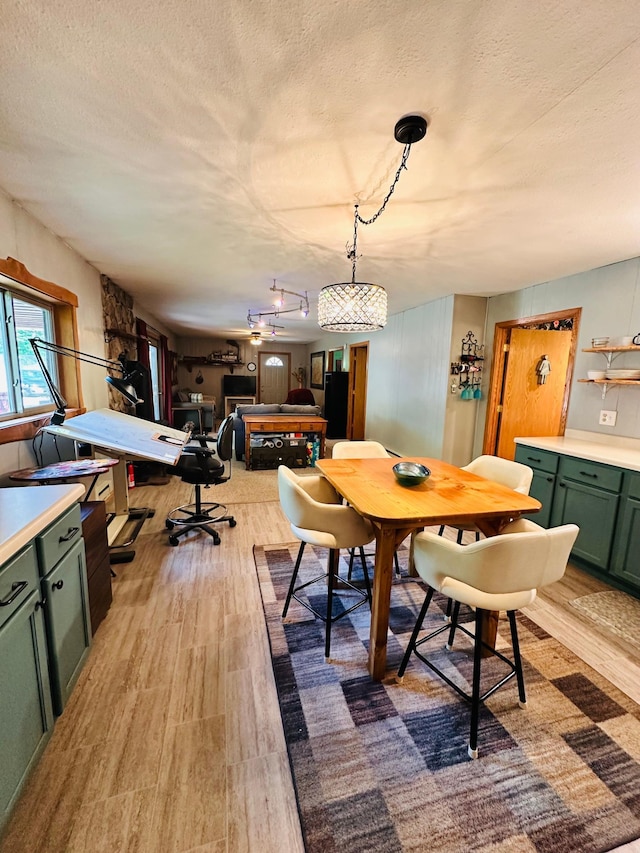 1414 E Shore Dr, Edgewater, WI 54817 - dining area with light wood-style flooring and a textured ceiling