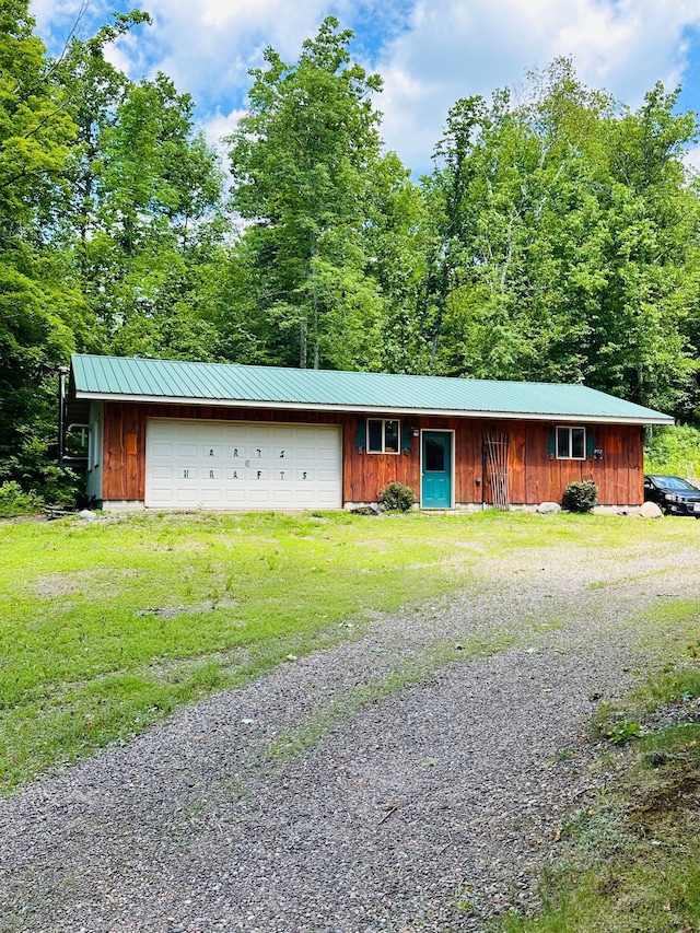 1414 E Shore Dr, Edgewater, WI 54817 - view of front of house with board and batten siding, a metal roof, a garage, driveway, and a front lawn