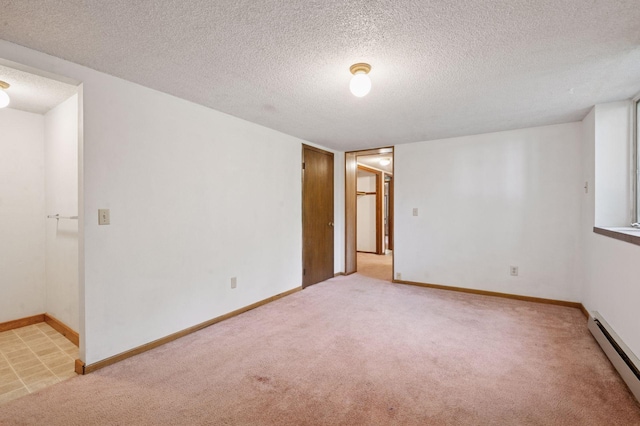 29908 108th St NW, Baldwin Twp, MN 55371 - unfurnished room featuring baseboard heating, light carpet, and a textured ceiling