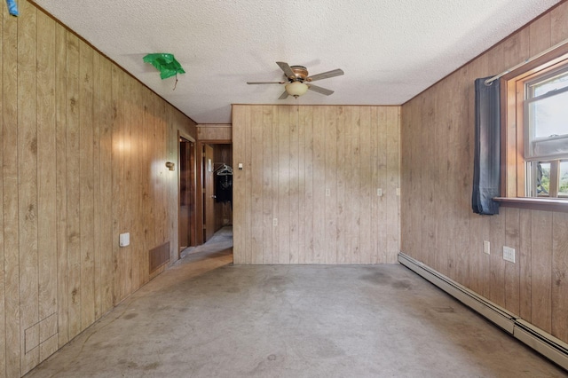 29908 108th St NW, Baldwin Twp, MN 55371 - unfurnished room featuring a baseboard heating unit, wood walls, ceiling fan, a textured ceiling, and carpet