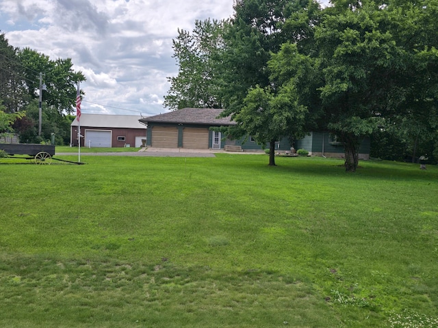 29908 108th St NW, Baldwin Twp, MN 55371 - view of grassy yard featuring a garage and an outdoor structure