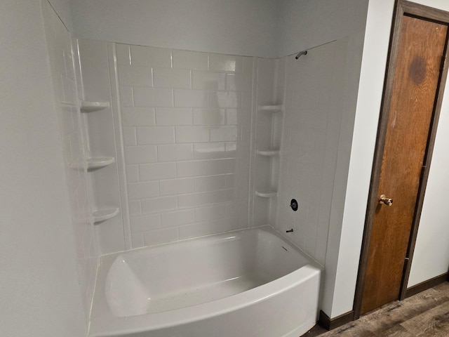 29908 108th St NW, Baldwin Twp, MN 55371 - bathroom with tub / shower combination and wood finished floors