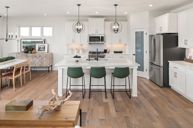 14643 107th Pl N, Maple Grove, MN 55369 - kitchen featuring appliances with stainless steel finishes, a chandelier, light countertops, and recessed lighting