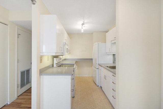 66 9th St E Unit 1315, Saint Paul, MN 55101 - kitchen with white appliances, white cabinets, and light countertops