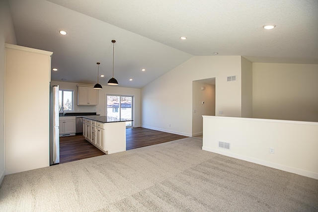 12051 Owatonna Ct, Blaine, MN 55449 - kitchen with dishwasher, dark colored carpet, vaulted ceiling, dark countertops, and recessed lighting