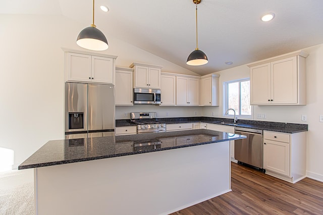 12051 Owatonna Ct, Blaine, MN 55449 - kitchen with appliances with stainless steel finishes, vaulted ceiling, a center island, dark wood finished floors, and white cabinets