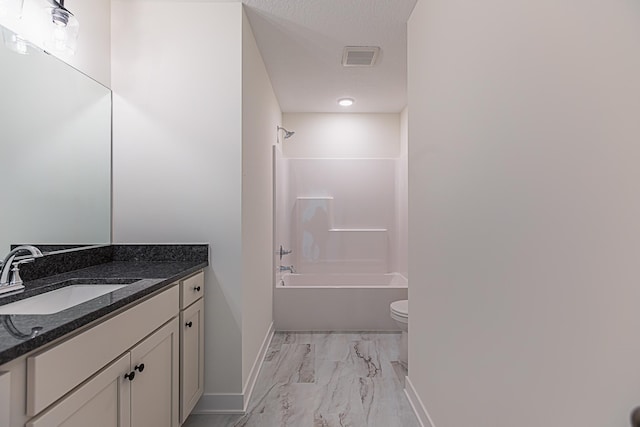 12051 Owatonna Ct, Blaine, MN 55449 - bathroom with vanity, marble look tiles, and bathtub / shower combination