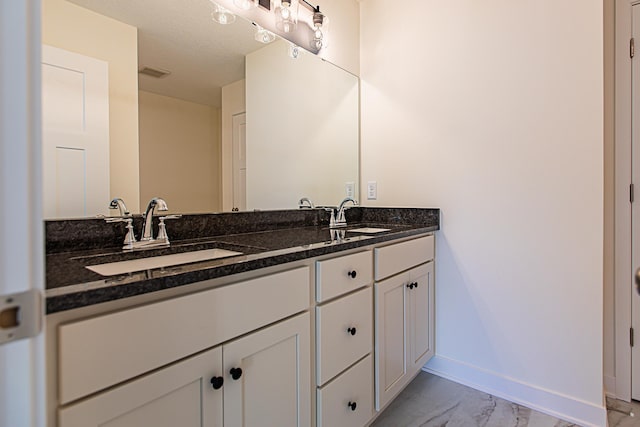 12051 Owatonna Ct, Blaine, MN 55449 - bathroom featuring double vanity and marble finish flooring