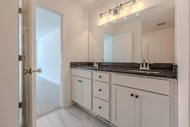 12051 Owatonna Ct, Blaine, MN 55449 - bathroom featuring double vanity and marble look tile flooring