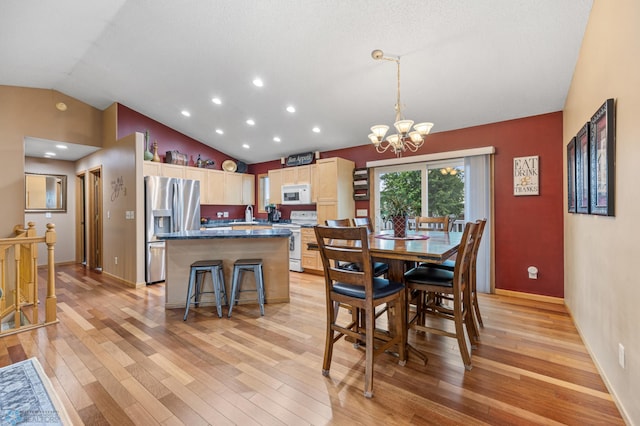 817 16th Avenue Ct W, West Fargo, ND 58078 - dining room featuring lofted ceiling, light wood finished floors, a chandelier, and recessed lighting
