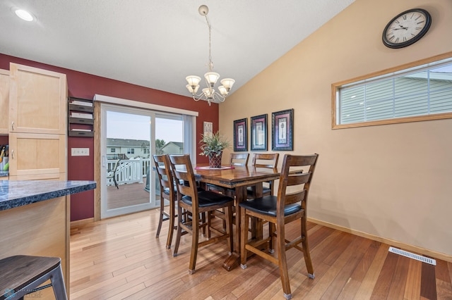 817 16th Avenue Ct W, West Fargo, ND 58078 - dining room featuring a chandelier, light wood finished floors, and vaulted ceiling