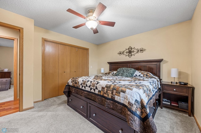 817 16th Avenue Ct W, West Fargo, ND 58078 - bedroom with light colored carpet, a closet, a ceiling fan, and a textured ceiling