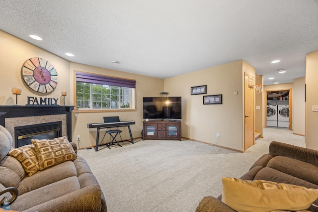 817 16th Avenue Ct W, West Fargo, ND 58078 - living room with washer and dryer, carpet floors, a glass covered fireplace, a textured ceiling, and recessed lighting