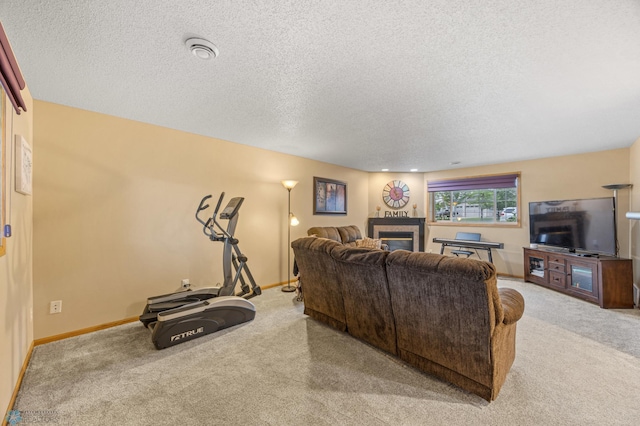 817 16th Avenue Ct W, West Fargo, ND 58078 - living area with carpet flooring, a textured ceiling, and a glass covered fireplace
