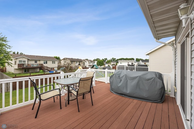 817 16th Avenue Ct W, West Fargo, ND 58078 - wooden deck with a residential view, area for grilling, a fenced backyard, and outdoor dining area