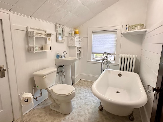 221 3rd St, Moose Lake, MN 55767 - full bathroom with radiator heating unit, vaulted ceiling, and a freestanding bath