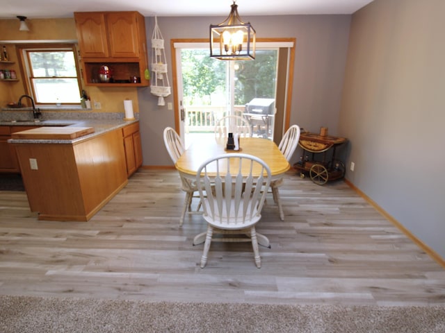 237 Plainview Dr, Troy Twp, WI 54022 - dining room with light wood-style flooring, a chandelier, and plenty of natural light