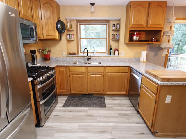 237 Plainview Dr, Troy Twp, WI 54022 - kitchen featuring stainless steel appliances, open shelves, a peninsula, and light wood-style flooring