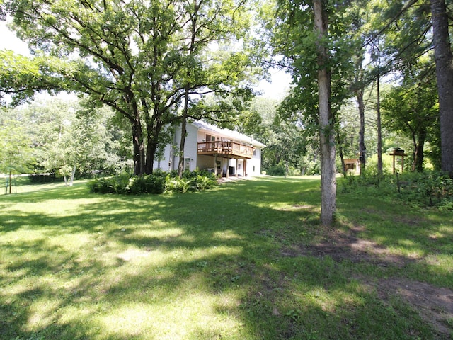 237 Plainview Dr, Troy Twp, WI 54022 - view of green lawn featuring a wooden deck and view of wooded area