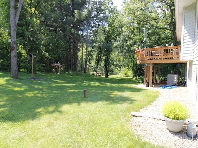 237 Plainview Dr, Troy Twp, WI 54022 - view of grassy yard featuring a wooden deck and view of scattered trees