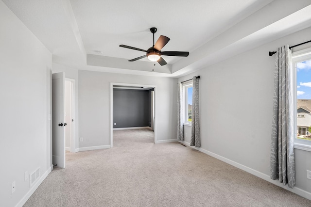 14221 Aspen Ave, Rosemount, MN 55068 - empty room featuring a raised ceiling, light colored carpet, and ceiling fan