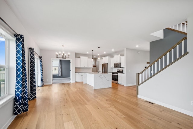 14221 Aspen Ave, Rosemount, MN 55068 - unfurnished living room featuring a chandelier, light wood-style flooring, stairs, and recessed lighting