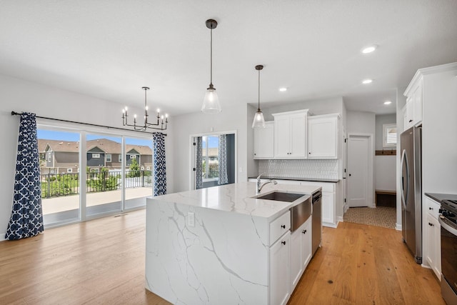 14221 Aspen Ave, Rosemount, MN 55068 - kitchen with stainless steel appliances, light wood-style floors, a chandelier, white cabinets, and recessed lighting