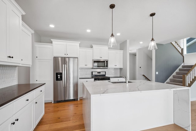 14221 Aspen Ave, Rosemount, MN 55068 - kitchen featuring appliances with stainless steel finishes, decorative backsplash, light wood finished floors, recessed lighting, and white cabinetry