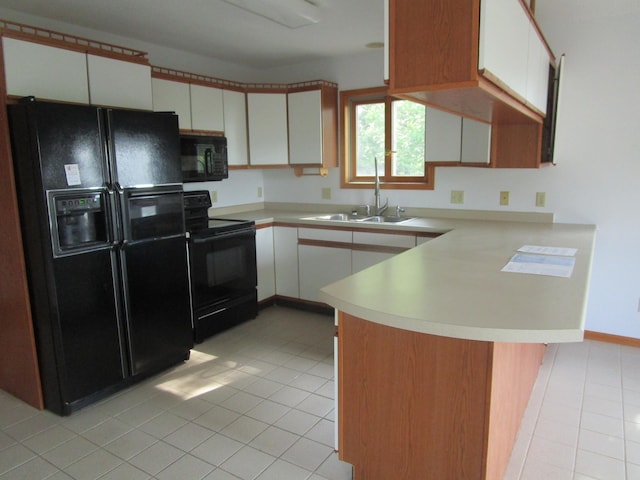 32468 County Highway 27, Elizabeth Twp, MN 56534 - kitchen with black appliances, a peninsula, light countertops, light tile patterned floors, and white cabinets
