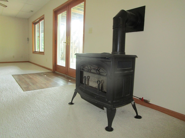 32468 County Highway 27, Elizabeth Twp, MN 56534 - entryway featuring carpet, a wood stove, french doors, and a drop ceiling