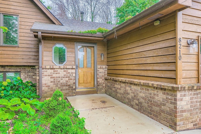 8210 208th St W, Lakeville, MN 55044 - doorway to property with brick siding and a shingled roof
