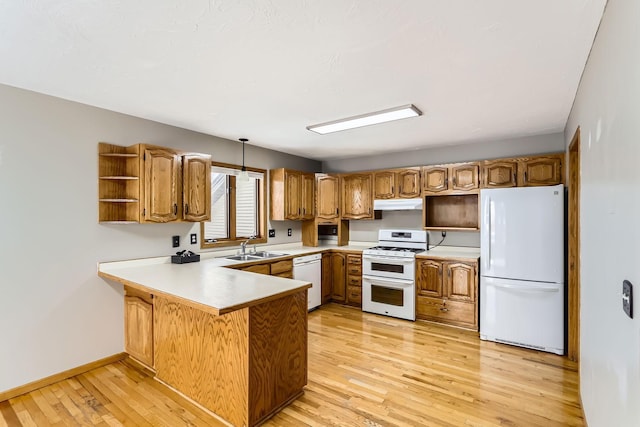 8210 208th St W, Lakeville, MN 55044 - kitchen featuring white appliances, under cabinet range hood, open shelves, a peninsula, and light wood-style flooring