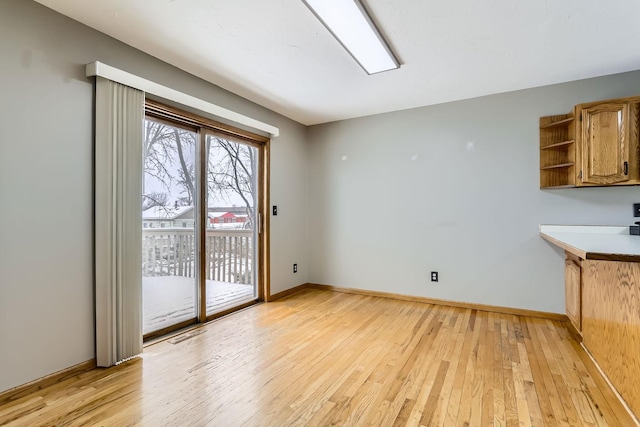 8210 208th St W, Lakeville, MN 55044 - unfurnished dining area with light wood-style floors and baseboards