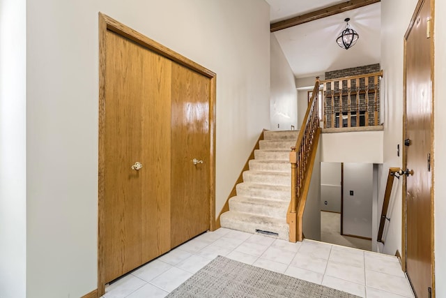 8210 208th St W, Lakeville, MN 55044 - stairway with tile patterned floors and beam ceiling