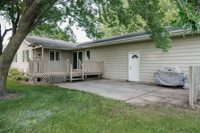 600 Venn St, Sherburn, MN 56171 - rear view of house featuring a patio, a wooden deck, a yard, and a shingled roof