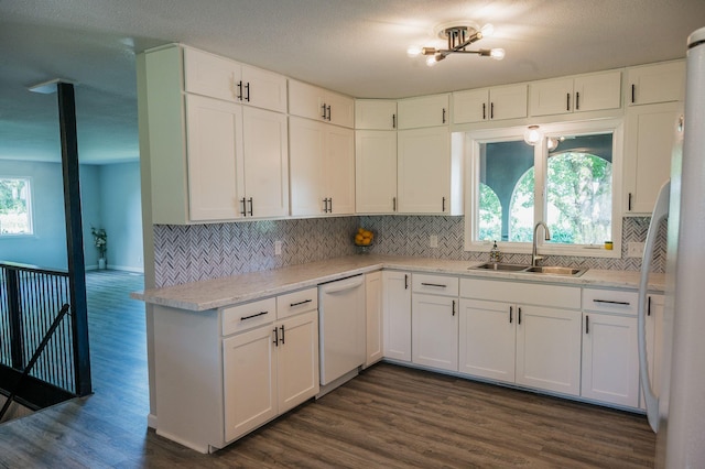 600 Venn St, Sherburn, MN 56171 - kitchen featuring white appliances, backsplash, dark wood-style floors, and white cabinetry