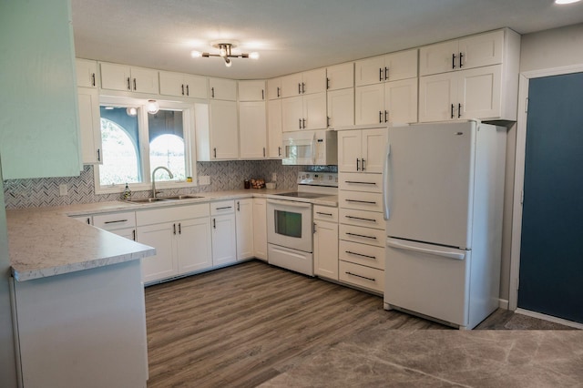 600 Venn St, Sherburn, MN 56171 - kitchen with white appliances, light countertops, decorative backsplash, and white cabinetry