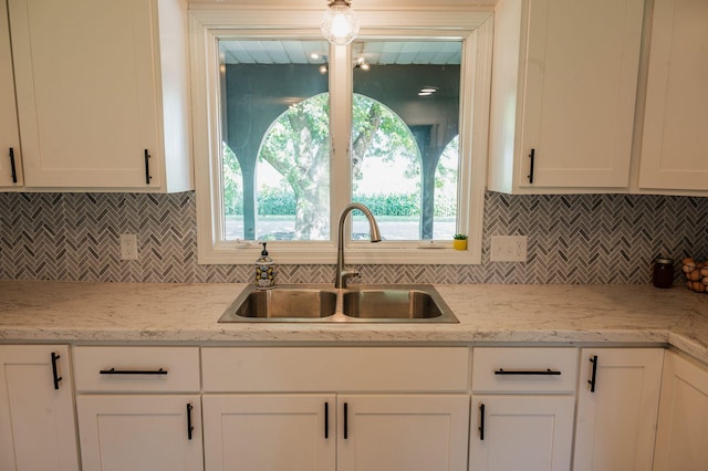 600 Venn St, Sherburn, MN 56171 - kitchen featuring white cabinets and backsplash